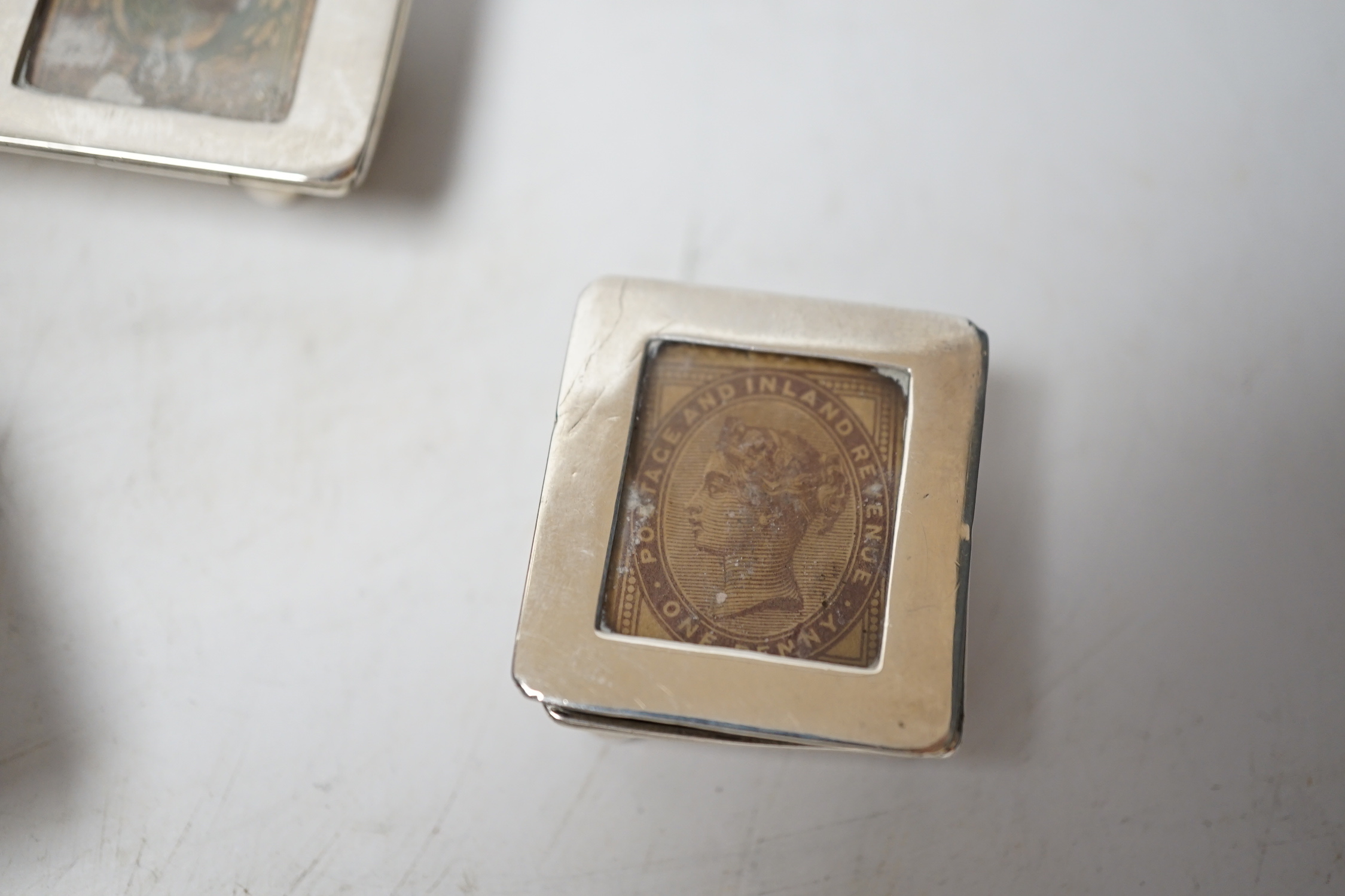 Four assorted late 19th/early 20th century silver stamp boxes, including triple compartment, one with enamelled 'stamps', largest 9cm and one plated stamp box.